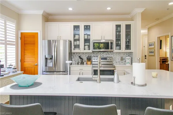 a kitchen with a sink and a refrigerator