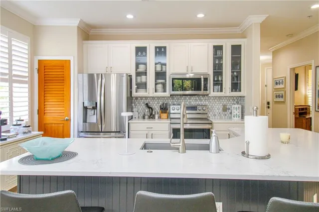 a kitchen with a sink and a refrigerator