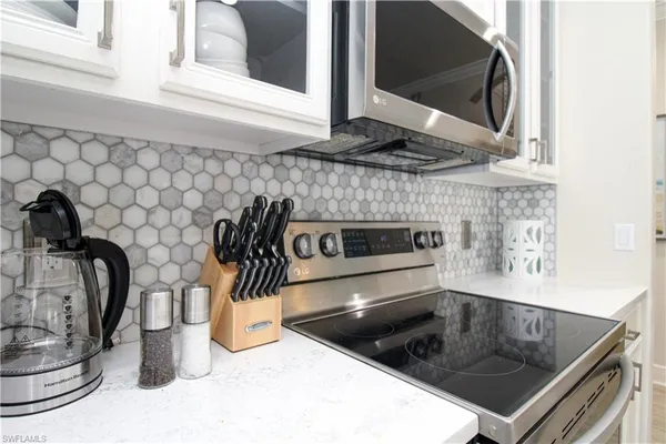 a kitchen with a sink and a stove top oven