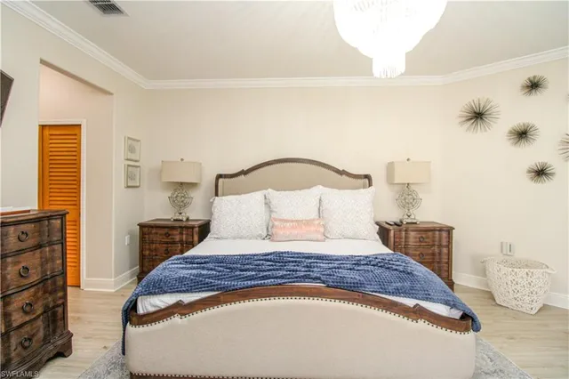 a bedroom with a large bed and a night stand