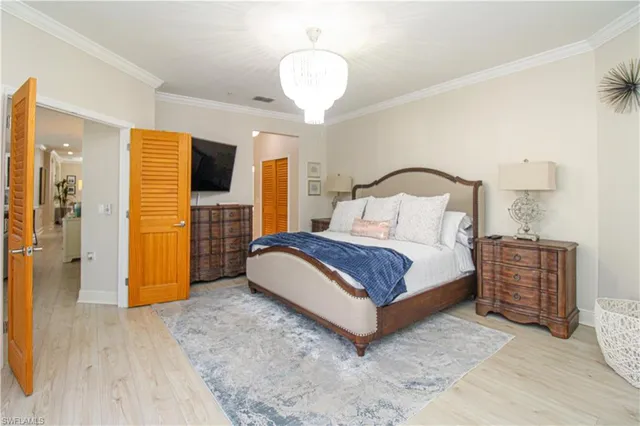 a bedroom with a bed and a chandelier