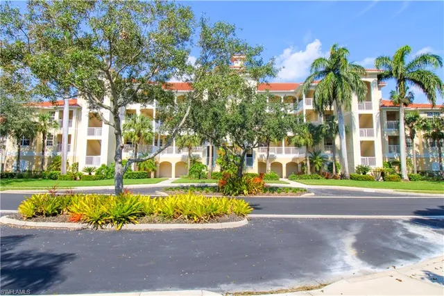 a front view of a house with a yard and a garage