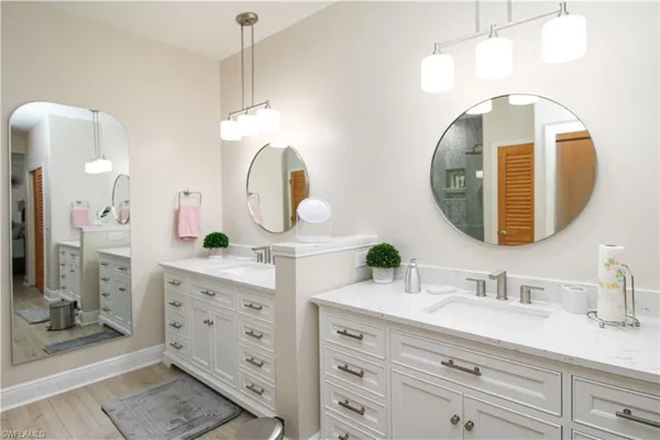 a bathroom with a double vanity sink mirror and double