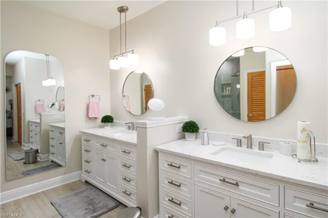 a bathroom with a double vanity sink mirror and double