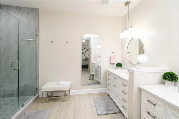 a spacious bathroom with a double vanity sink and a mirror