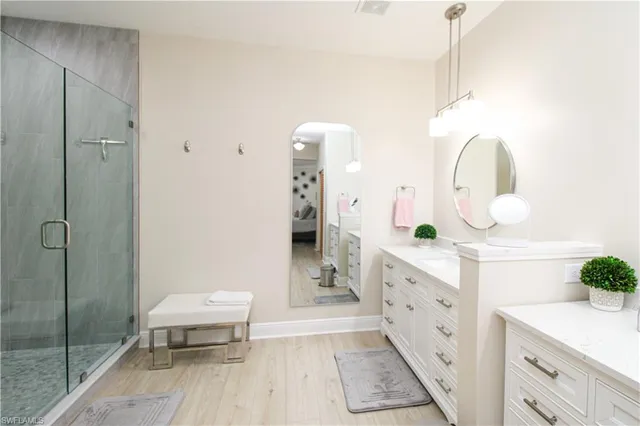 a spacious bathroom with a double vanity sink and a mirror