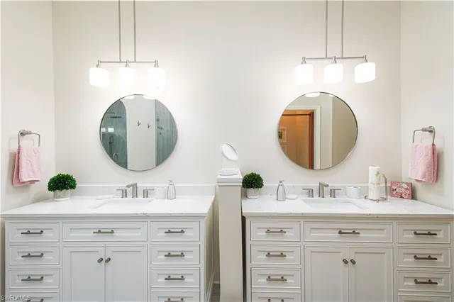 a bathroom with a double vanity sink and a mirror