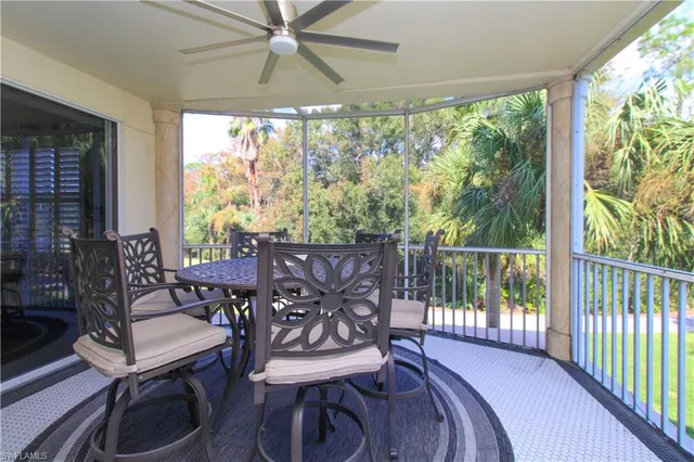 a view of a porch with furniture and a yard