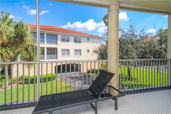 a view of a chair and tables in the balcony