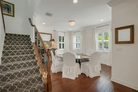 a dining room with furniture and wooden floor