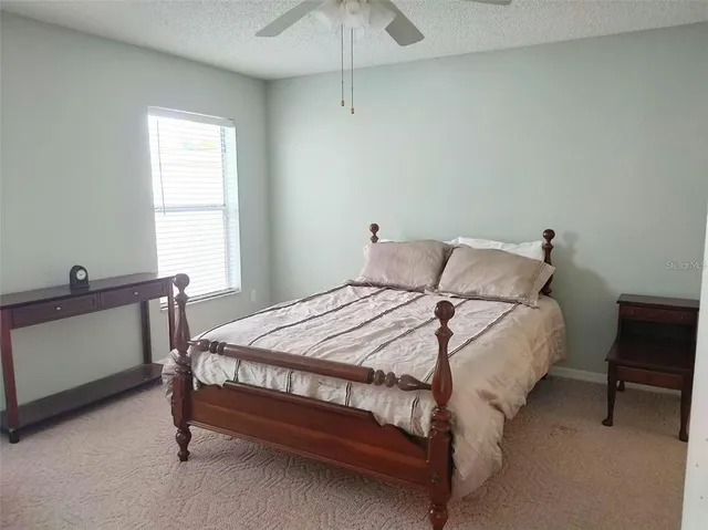 a bed sitting in a bedroom next to a window