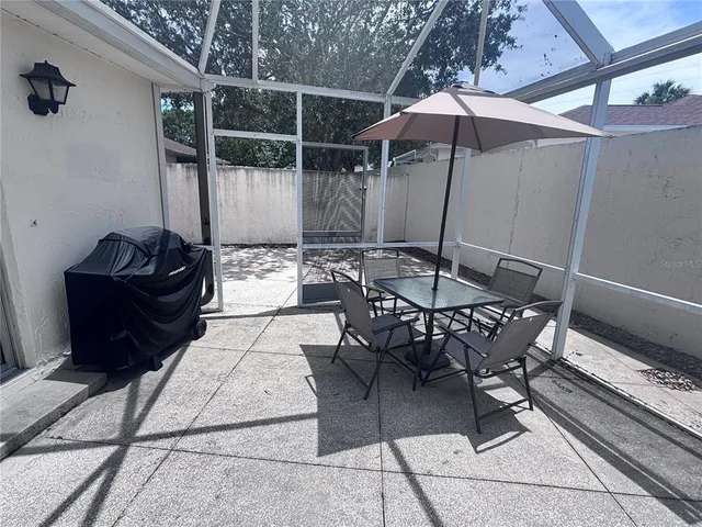 a view of a dinning table and chairs in the patio