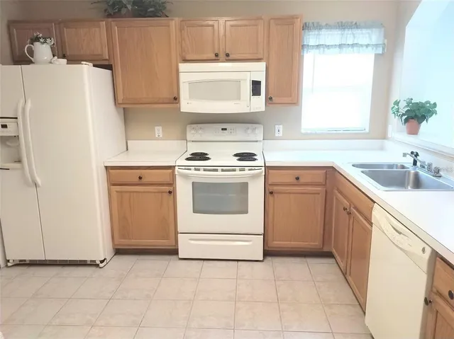 a kitchen with a sink a stove and refrigerator
