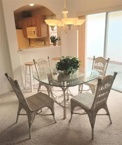 a view of a dining room with furniture and a chandelier