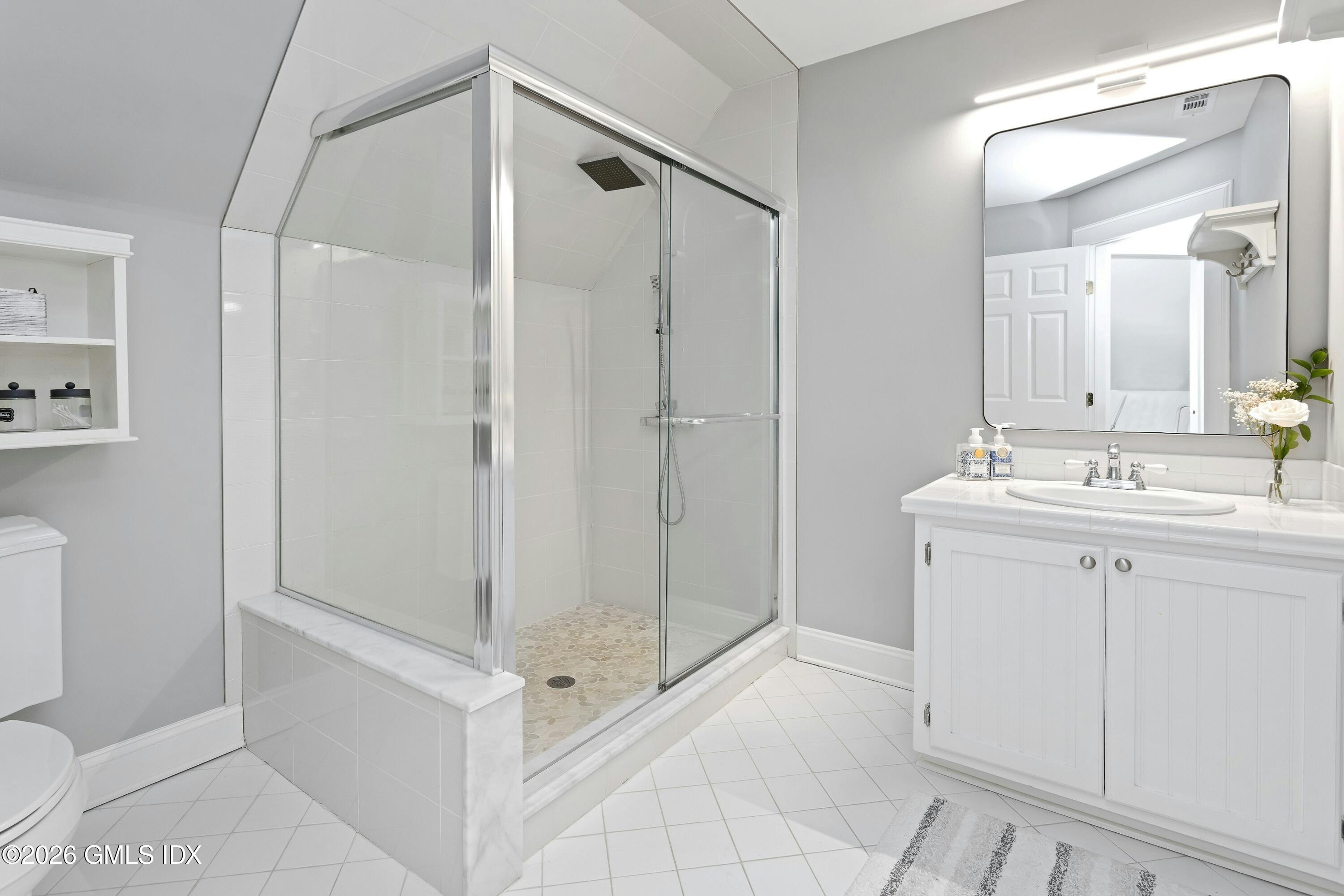 16 Summit Road Riverside, CT 06878 - Photo 23 of 34 a bathroom with a shower sink and mirror