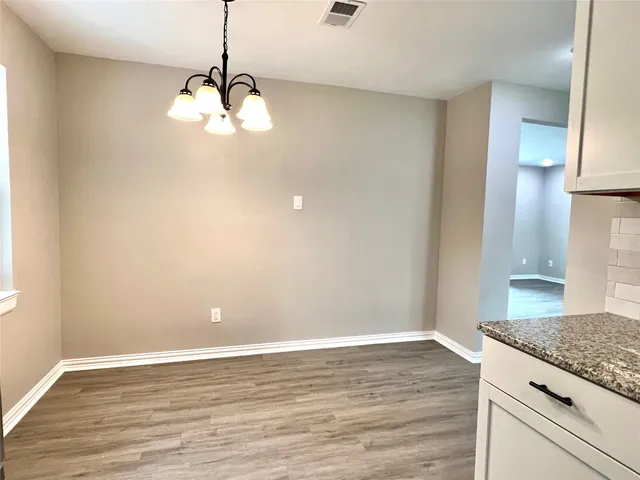 a view of a kitchen with a dishwasher cabinets and wooden floor