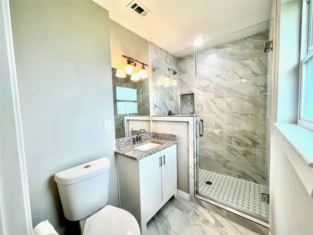 a bathroom with a toilet sink and shower