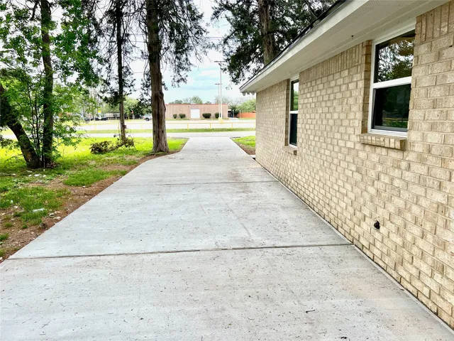 a front view of a house with a yard and an trees