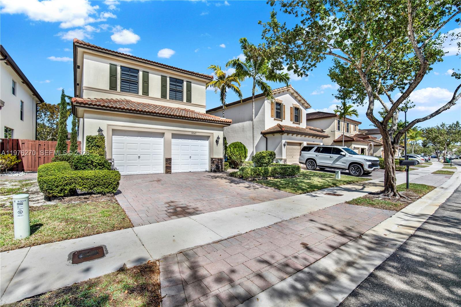 a front view of a house with a yard and a garage