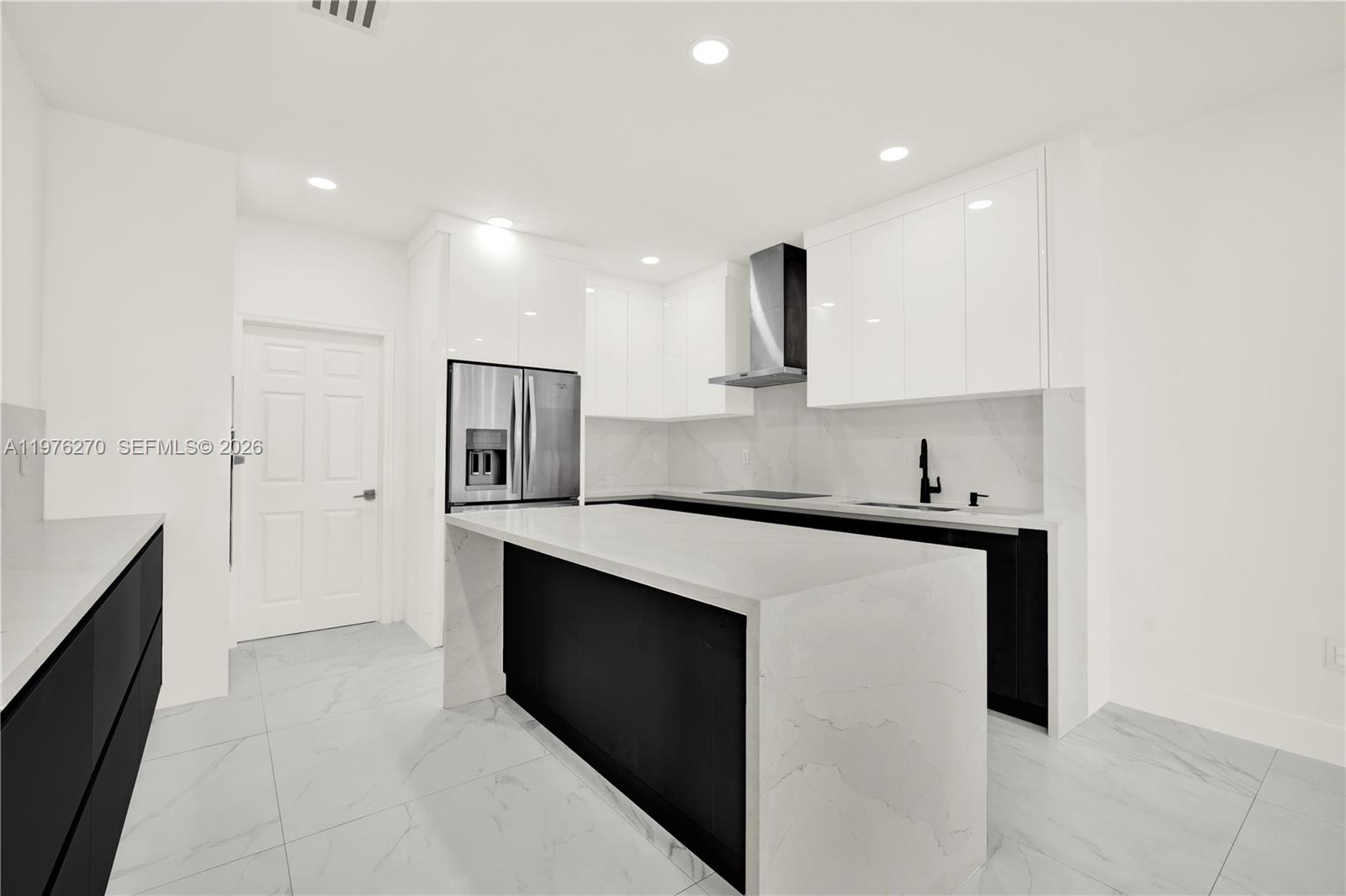 9243 Southwest 227th Terrace Cutler Bay, FL 33190 - Photo 20 of 32 a kitchen with white cabinets and stainless steel appliances