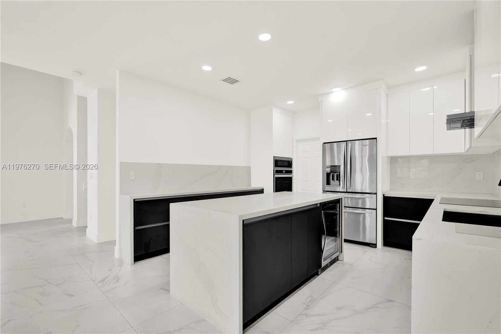 9243 Southwest 227th Terrace Cutler Bay, FL 33190 - Photo 23 of 32 a kitchen with stainless steel appliances kitchen island granite countertop a refrigerator and a stove top oven