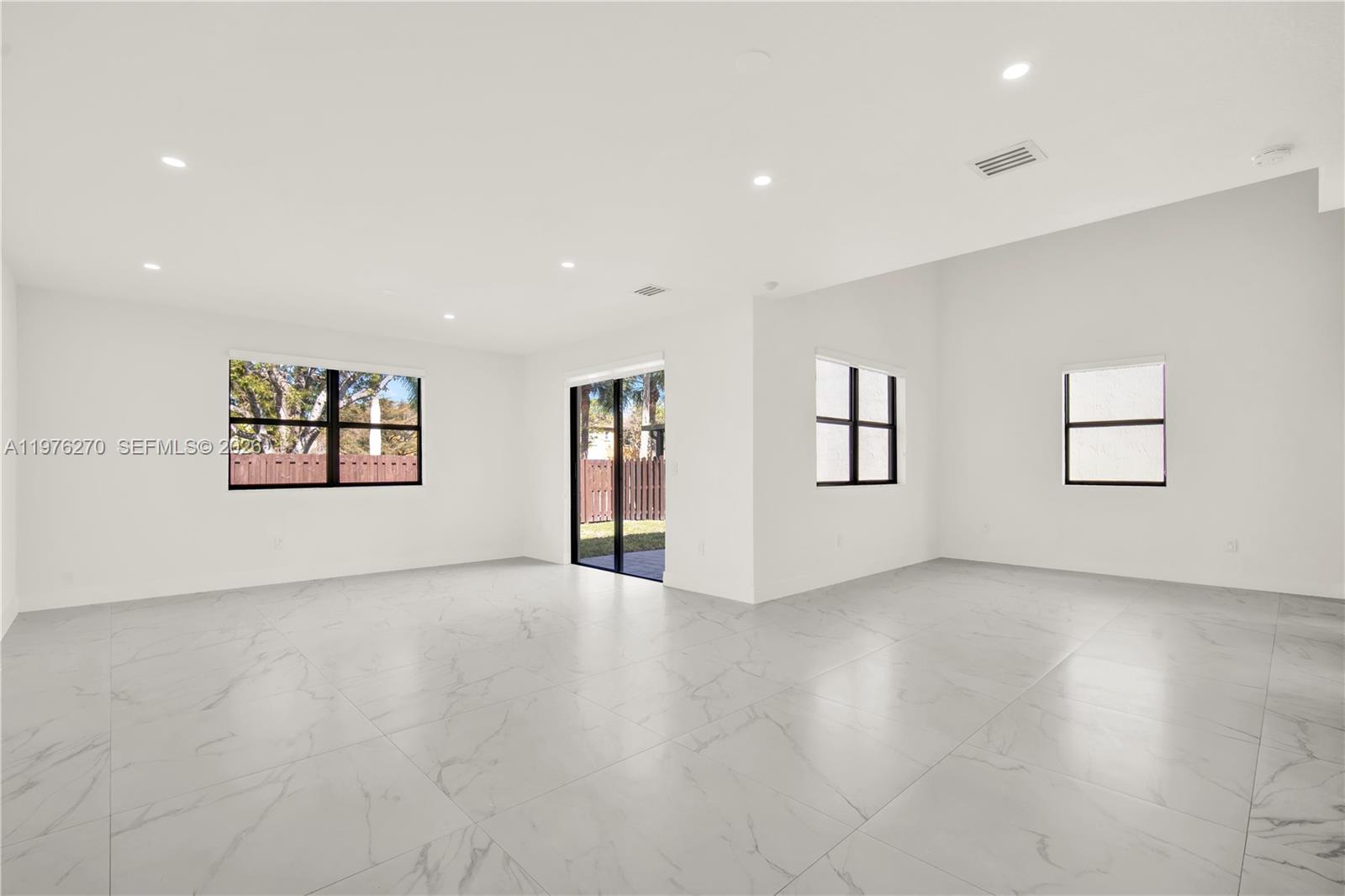 9243 Southwest 227th Terrace Cutler Bay, FL 33190 - Photo 26 of 32 a view of a livingroom with window