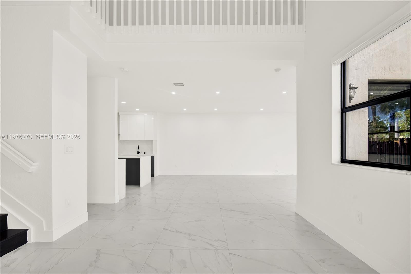 9243 Southwest 227th Terrace Cutler Bay, FL 33190 - Photo 28 of 32 a view of a kitchen with a refrigerator and a window