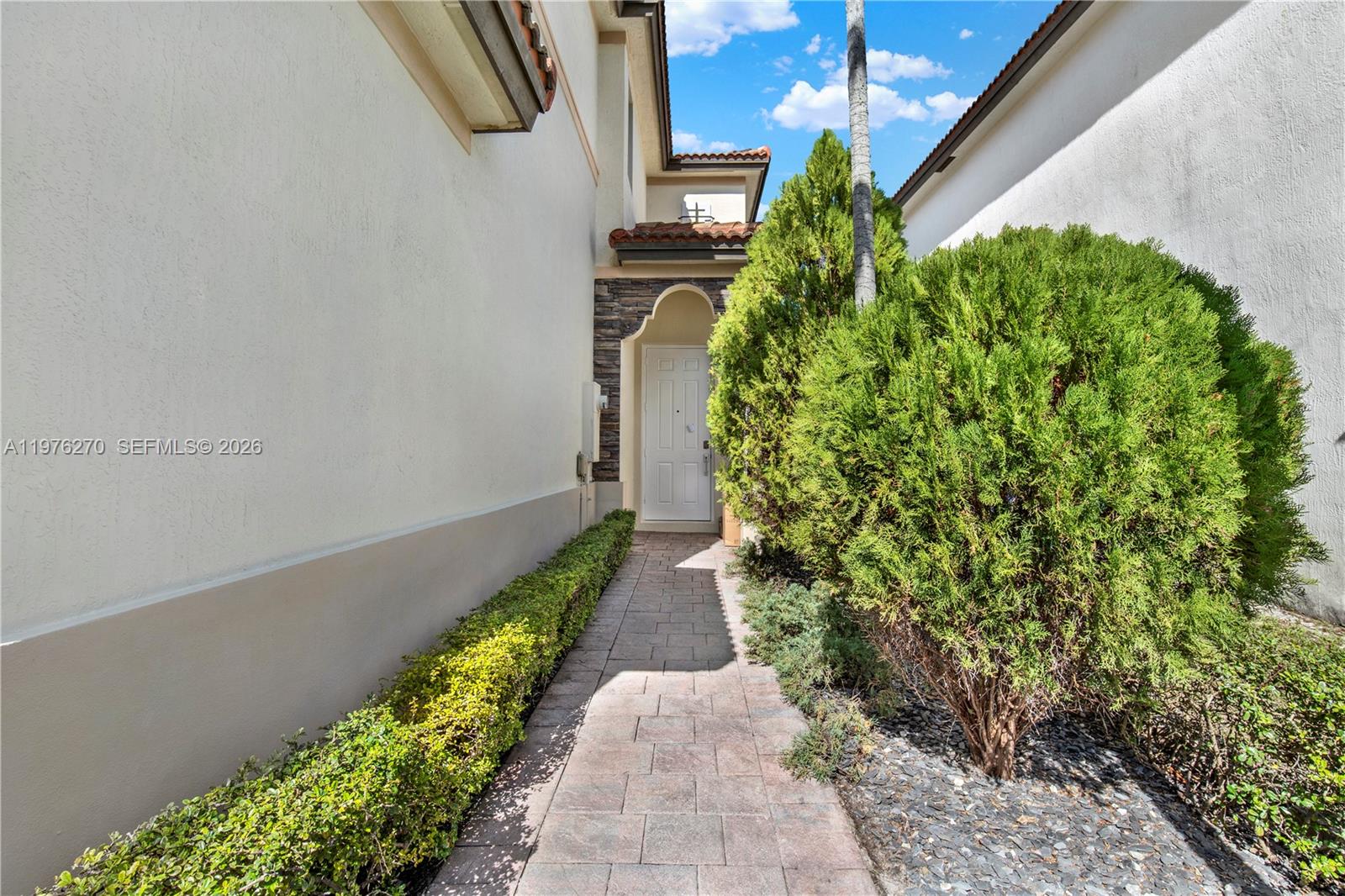 9243 Southwest 227th Terrace Cutler Bay, FL 33190 - Photo 4 of 32 a view of a pathway both side of flower