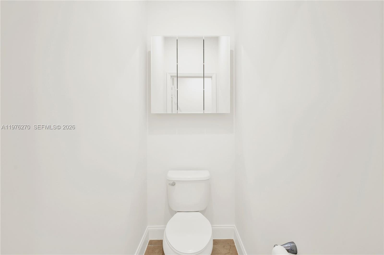 9243 Southwest 227th Terrace Cutler Bay, FL 33190 - Photo 6 of 32 a bathroom with a toilet