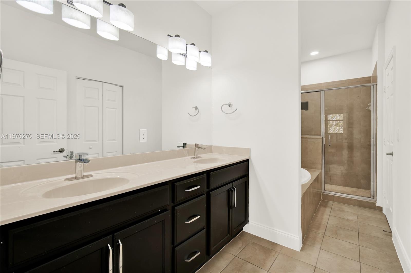 9243 Southwest 227th Terrace Cutler Bay, FL 33190 - Photo 9 of 32 a bathroom with a sink double vanity and a mirror