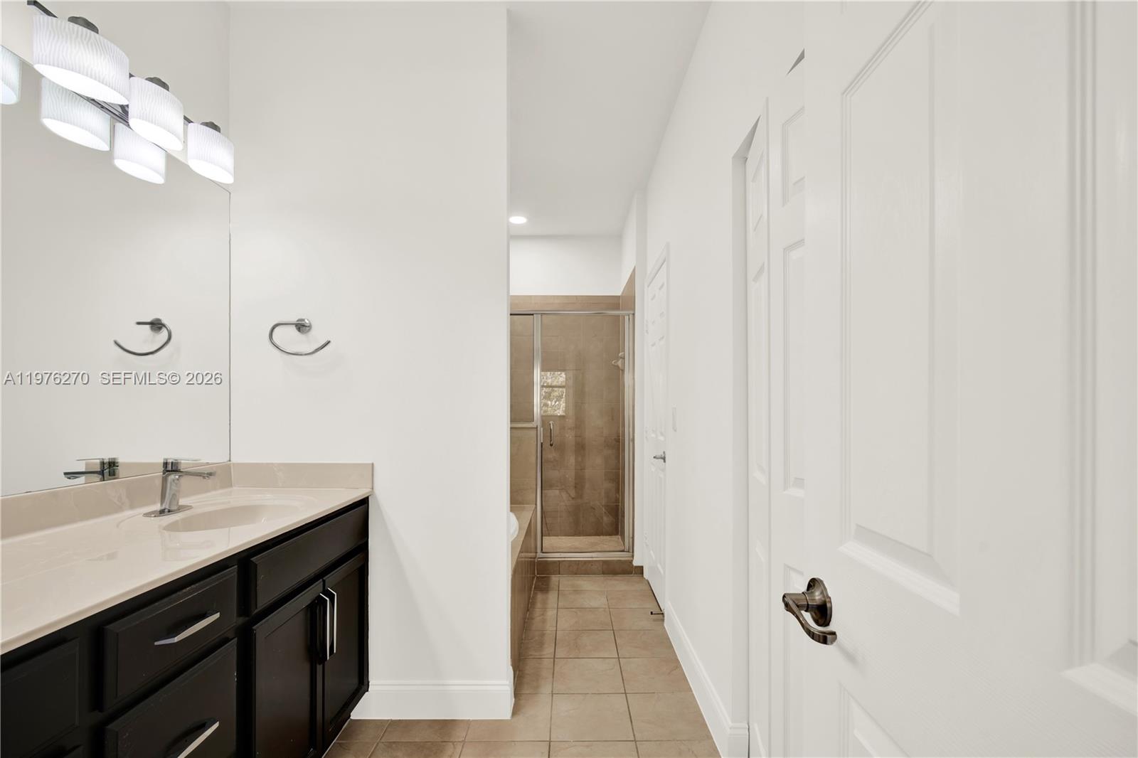 9243 Southwest 227th Terrace Cutler Bay, FL 33190 - Photo 10 of 32 a bathroom with a sink a tub and a mirror