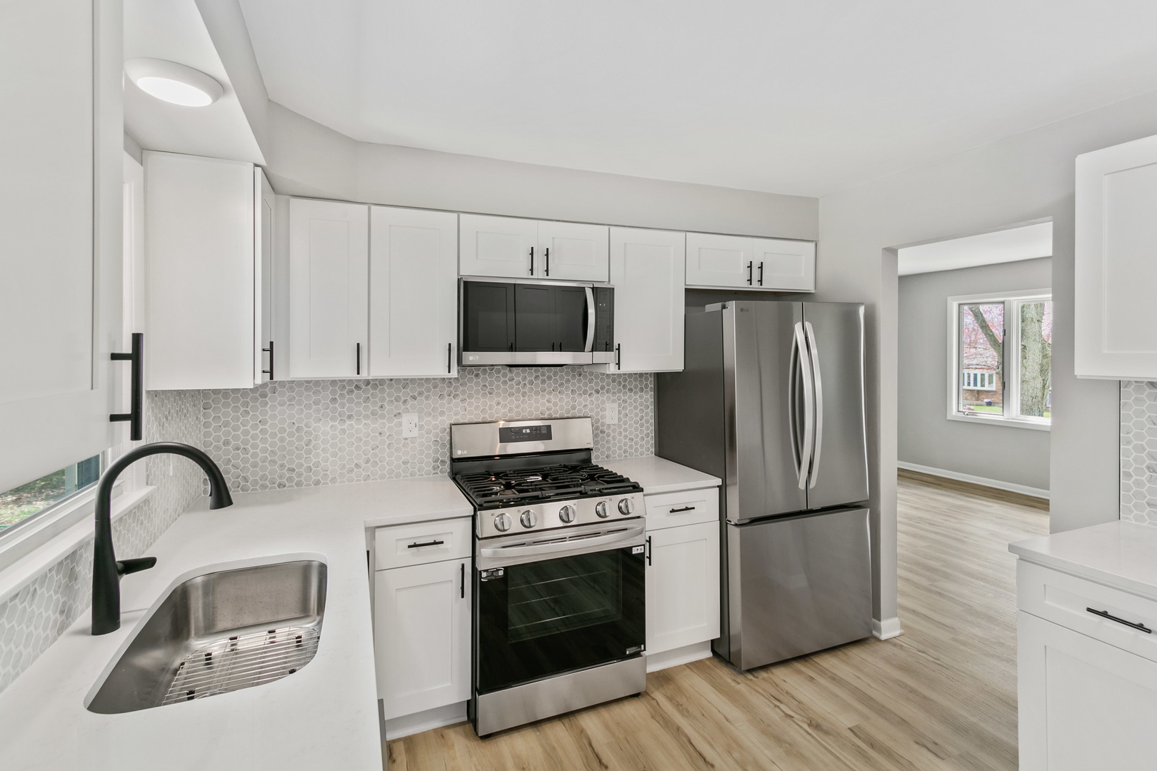 2110 Old Elm Road Lindenhurst, IL 60046 - Photo 3 of 19 a kitchen with a refrigerator sink and wooden floor