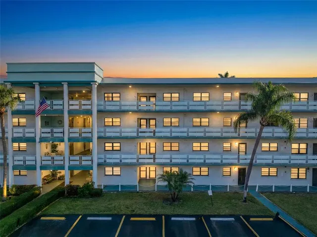 a front view of building with outdoor space and seating area