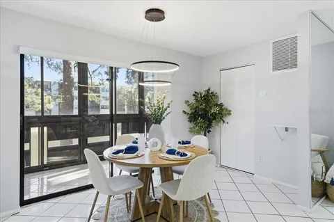 a view of a dining room with furniture and window