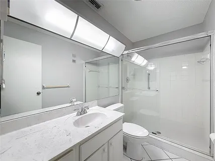 a bathroom with a shower and toilet