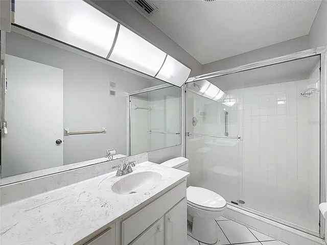 a bathroom with a shower and toilet