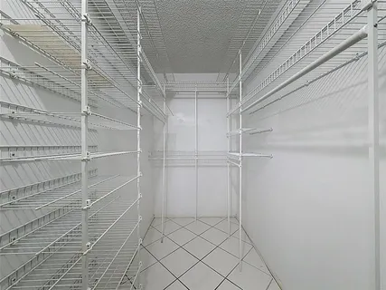 a view of a street with lots of cars parked on the road