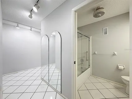 an aerial view of a residential apartment building in front of residential houses