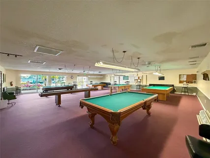 a room with pool table and lots of furniture