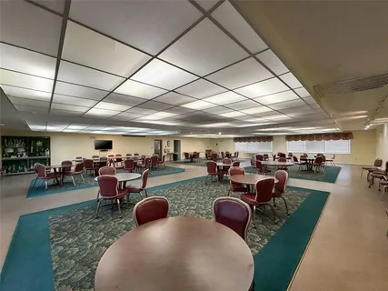 a room with lots of chairs and a projector screen