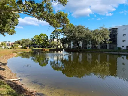 an aerial view of a city with lots of residential buildings ocean and mountain view in back