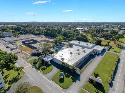 a living room with lots of furniture and a large window