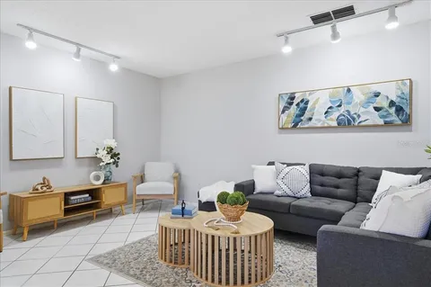 a living room with furniture and wooden floor