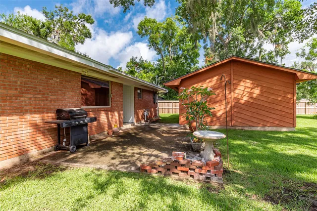 a backyard of a house with table and chairs