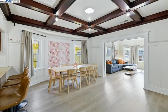 a view of a dining room with furniture a chandelier and wooden floor