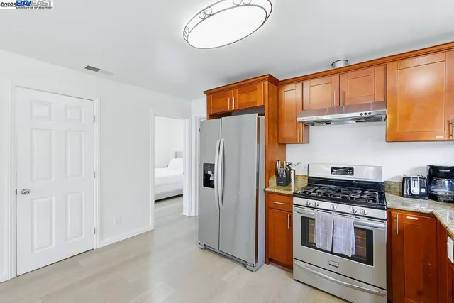 a kitchen with stainless steel appliances a refrigerator stove and sink