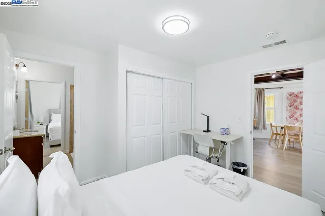 a bedroom with a bed and a table