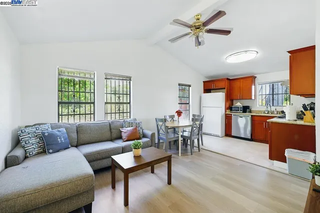 a living room with furniture a flat screen tv and a window