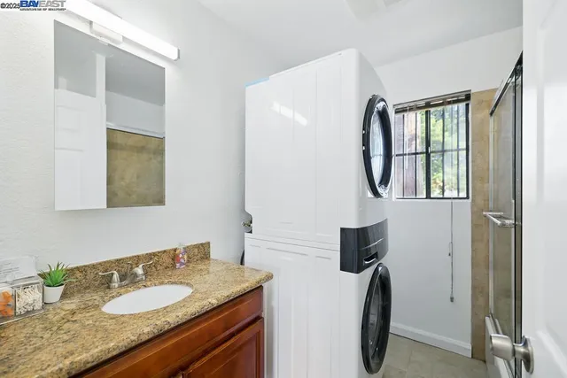 a bedroom with a bed and painting on the wall