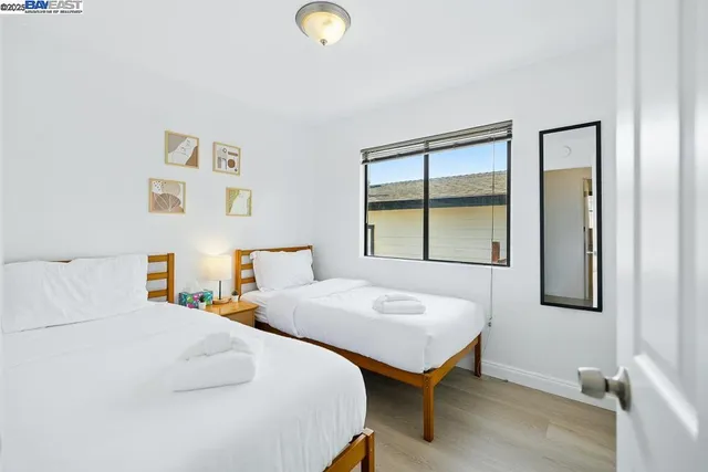 a bedroom with a bed and a large window